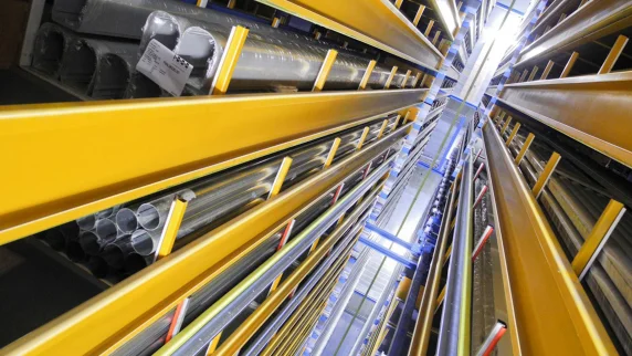View of the yellow-painted aisle of a high-bay warehouse where long goods (tubes, etc.) are stored